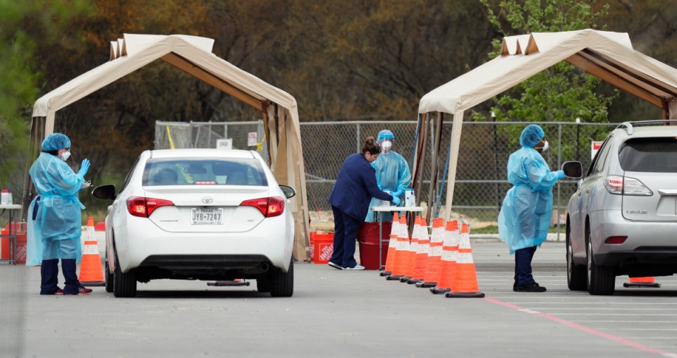 <strong>Medical workers test people for the coronavirus Tuesday, March 17, at a drive-thru facility in San Antonio, Texas. Tennessee Gov. Bill Lee said 15 such sites are being set up in Tennessee.</strong> (Eric Gay/AP)