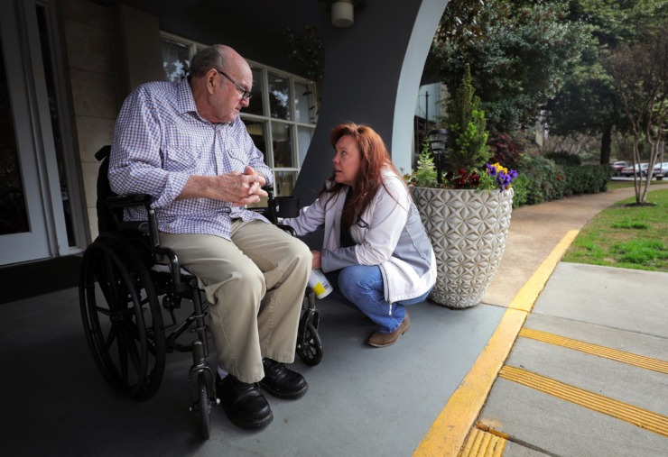 <strong>Margaret Walker sanitizes the wheelchair of her father, 80-year-old Henry Lantrip, while picking him outside of The Glenmary at Evergreen for a doctor's appointment on March 17, 2020. In the light of the coronavirus outbreak, visitors are not permitted inside the assisted living facility.</strong> (Patrick Lantrip/Daily Memphian)