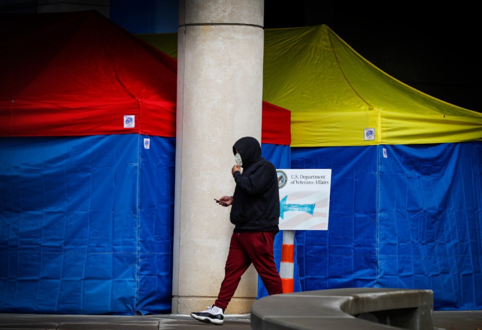 <strong>A man leaves the Memphis VA Medical Center wearing a mask on Wednesday, March 11, 2020. Due to the coronavirus pandemic, the hospital is using tents to pre-screen anyone who enters the facility.</strong> (Mark Weber/Daily Memphian)