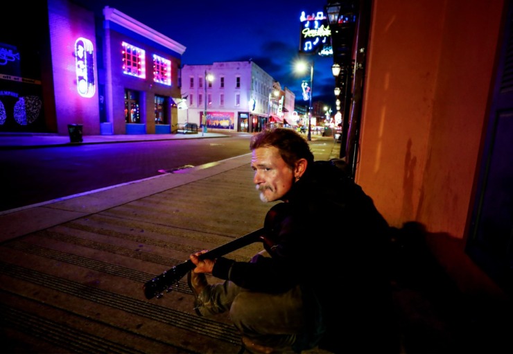 <strong>Musician Jamie Kenton strums his guitar on a vacant Beale Street on St. Patrick&rsquo;s Day Tuesday, March 17, 2020.</strong> (Mark Weber/Daily Memphian)
