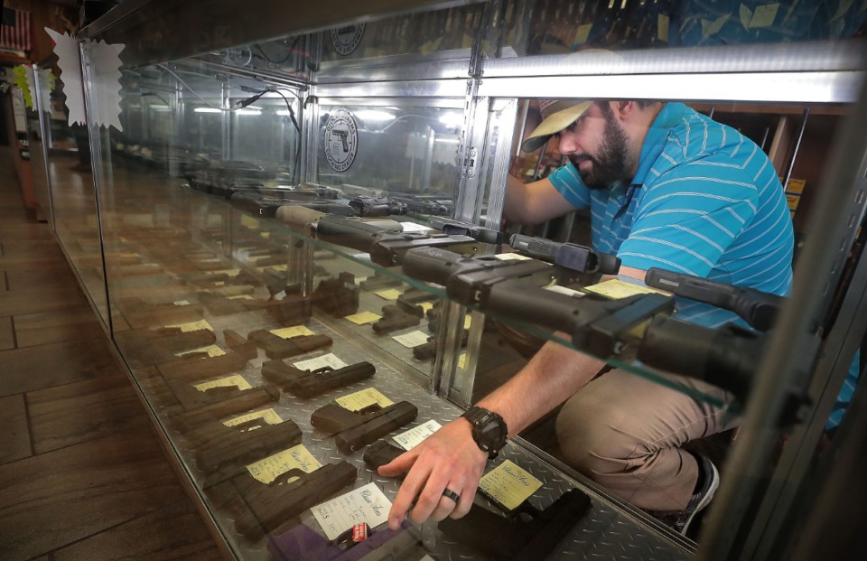 <strong>Assistant manager Chris Richardson spends a second day trying to keep up with demand at the Classic Arms of Memphis gun store in Cordova on March 17, 2020, where guns and ammo are "flying off the shelves" as social unrest and home protection become a concern for some in the wake of COVID-19.</strong> (Jim Weber/Daily Memphian)