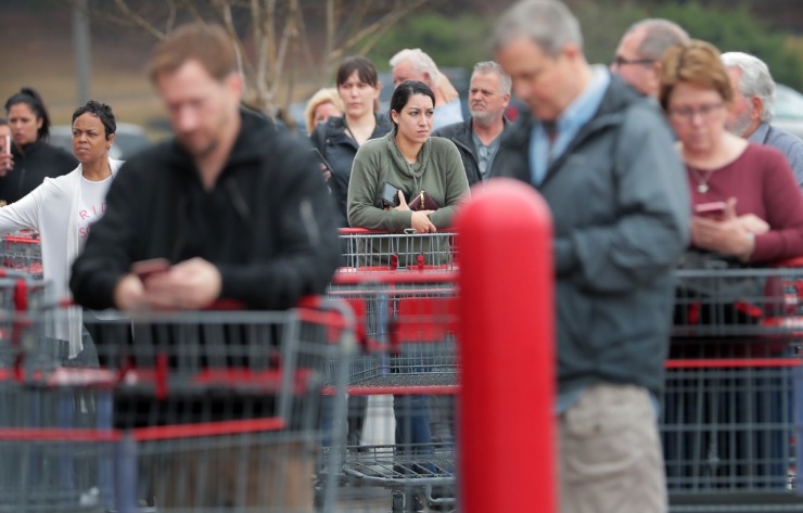 <strong>Shoppers line up outside the busy Costco on Germantown Parkway as management attempts to comply with federal social distancing guidelines by allowing 10-20 customers into the store periodically, a policy designed to control checkout lines and crowding inside the store.</strong> (Jim Weber/Daily Memphian)