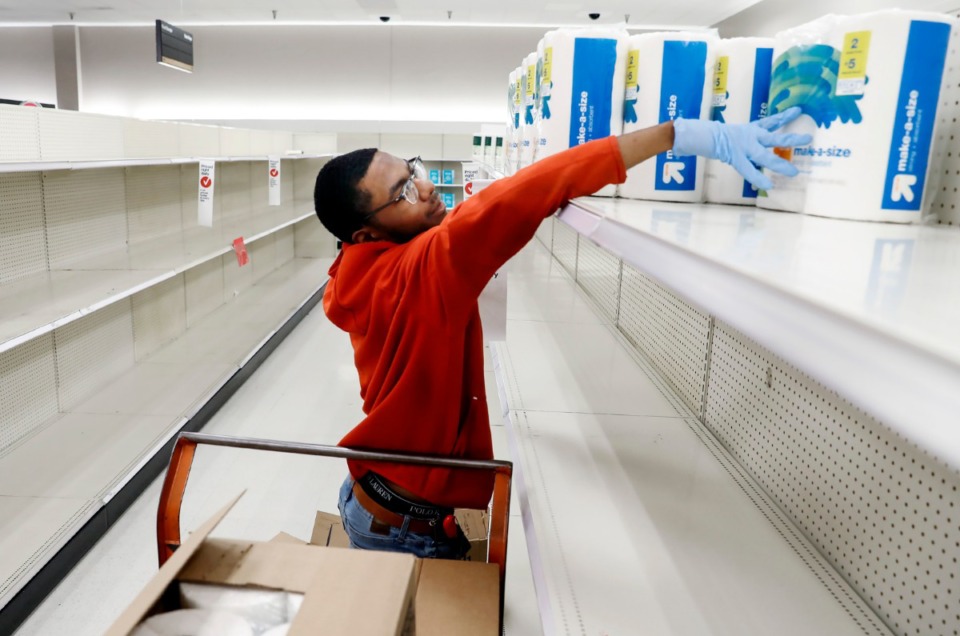 <strong>Target Memphis Central team member Davunshae Gainer stocked depleted shelves with paper towels on Thursday, March 19, 2020. Since the outbreak of the coronavirus, the store replaces their cleaning supplies and paper good daily and by the afternoon they are gone.</strong> (Mark Weber/Daily Memphian)