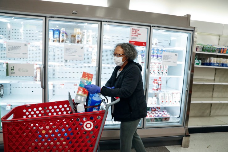 <strong>Target Memphis Central customer Aggie Gaddy wears a medical face mask while perusing the depleted grocery aisles on Thursday, March 19, 2020. Since the outbreak of the coronavirus, the store replaces their cleaning supplies and paper good daily and by the afternoon they are gone.</strong> (Mark Weber/Daily Memphian)