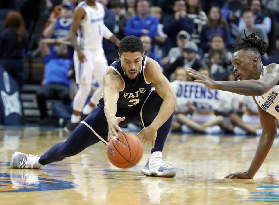 <strong>University of Memphis forward Kyvon Davenport (right) stretches to get a loose ball as Yale's Alex Copeland does the same during the Nov. 17 game at FedExForum in Memphis.&nbsp;</strong>(Karen Pulfer Focht/Special to The Daily Memphian)