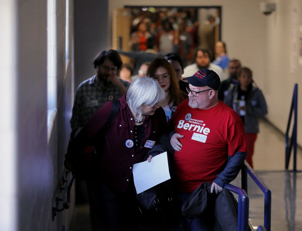 <strong>Alice Miller checks out David Perry's Bernie Sanders shirt during a convention at Kirby High School March 7, 2020, at the first of two events to decide who will be the official delegates to this summer's Democratic National Convention in Milwaukee.</strong> (Patrick Lantrip/Daily Memphian)
