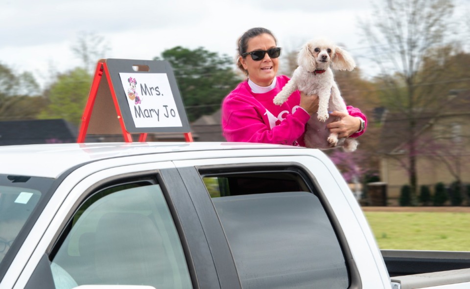 <strong>Bailey Station Elementary School preschool teacher rides through the neighborhoods of the school's students with her dogs Monday, March 23, 2020.</strong> (Greg Campbell/Special to The Daily Memphian)