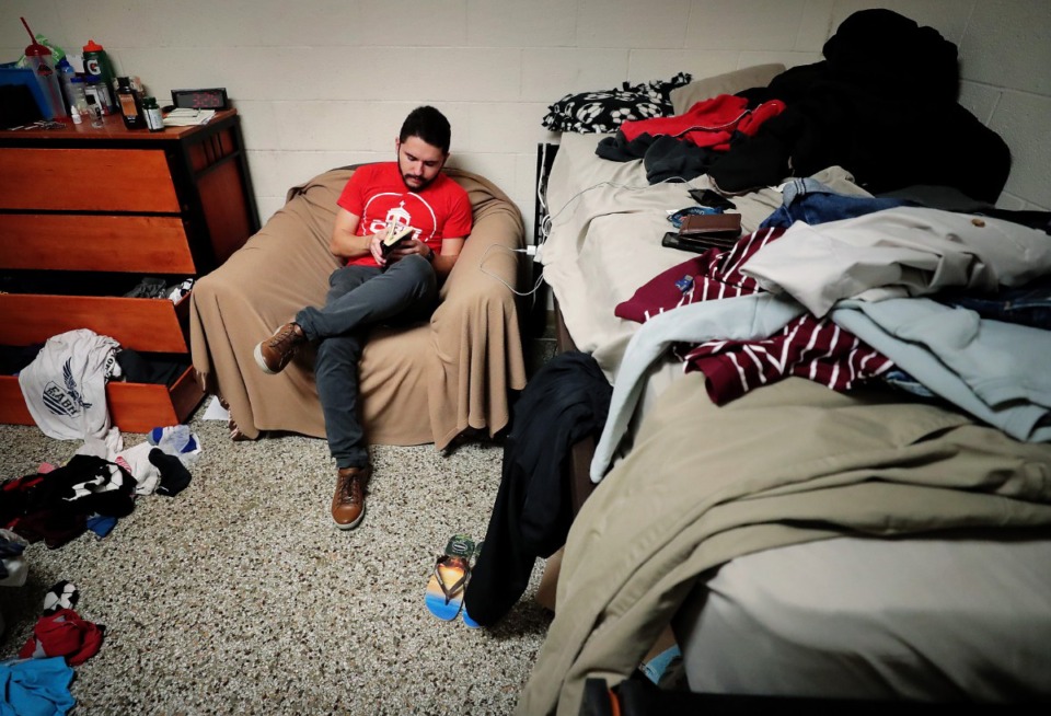 <strong>CBU engineering student Luiz Parolini Dutra, like many other international students, is languishing in the dorm on March, 24, 2020, as he begins remote course work. Luiz says he had packed up all his belongings because he thought he was going to have to switch rooms, but it didn't happen so now everything is a mess. He spends a lot of time in the cafeteria where food service is still operating, but calming the anxiety and boredom is a one-person show.</strong> (Jim Weber/Daily Memphian)