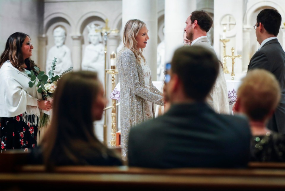 <strong>Holly Whittle (left) gazes at her bridegroom John Steinert during their wedding on Saturday, March 21, 2020 at St. Louis Catholic Church.</strong> (Mark Weber/Daily Memphian)
