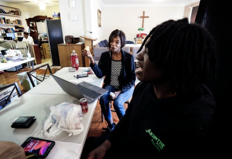 <strong>Dinishia Jones (left) smiles at her son Therron Farsee, Jr. in the office of HER Faith Ministries on Tuesday, March 24, 2020. Mother and son have been living the ministry's office for nearly a week after Jones lost her job as a server on Beale St. after the coronavirus outbreak.</strong> (Mark Weber/Daily Memphian)