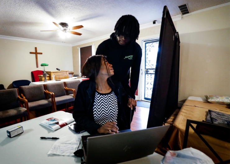 <strong>Dinishia Jones is comforted by her son Therron Farsee, Jr., while filing online job applications on Tuesday, March 24, 2020 at HER Faith Ministries.</strong> (Mark Weber/Daily Memphian)