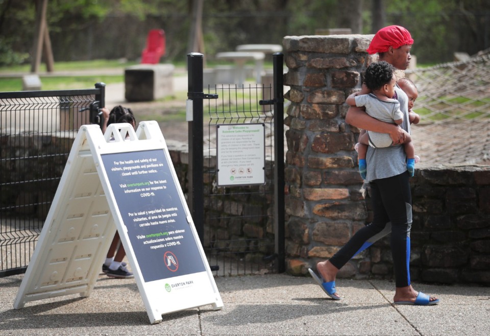 <strong>A sign at the Overton Park playground explains why the playground is closed, but some Memphians were ignoring the warning on Friday, March 27, 2020, which is one of the reasons why City officials have threatened to shutter parks entirely.</strong> (Jim Weber/Daily Memphian)