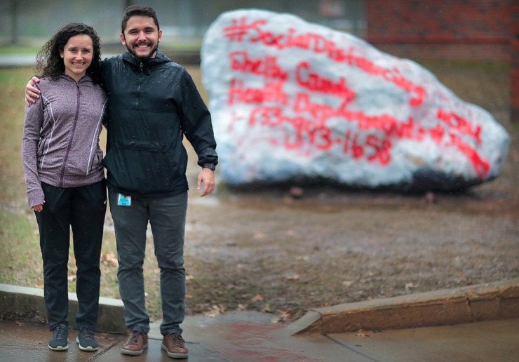 <strong>Siblings Amanda Parolini Dutra (left) and Luiz Parolini Dutra, CBU&nbsp; engineering students from Brazil, stand by a conversation rock on campus painted with the phone number of the Shelby County Health Department. Like many other international students, the pandemic has forced the pair to languish in their dorms, although Amanda has purchased a plane ticket and will return home soon.</strong> (Jim Weber/Daily Memphian)