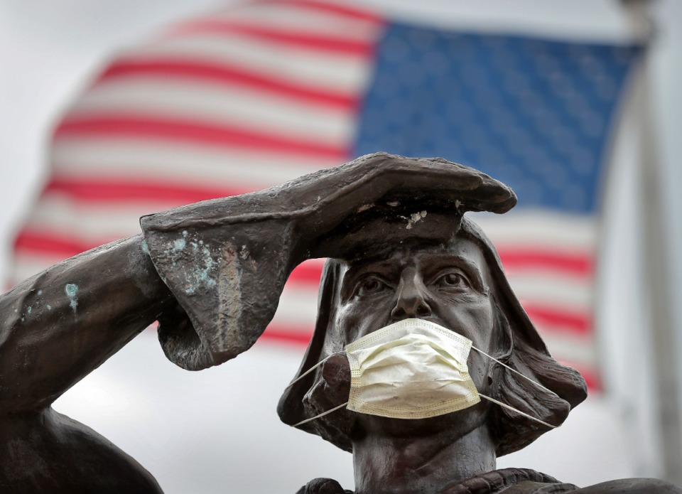 <strong>The bronze statue of famous Italian explorer Christopher Columbus got a little virus protection of his own after someone attached a mask overnight on March 28, 2020, at Marquette Park. The number of confirmed cases of COVID-19 has climbed over 300 in the greater Memphis area, with over 1,200 in the state of Tennessee.</strong> (Jim Weber/Daily Memphian)