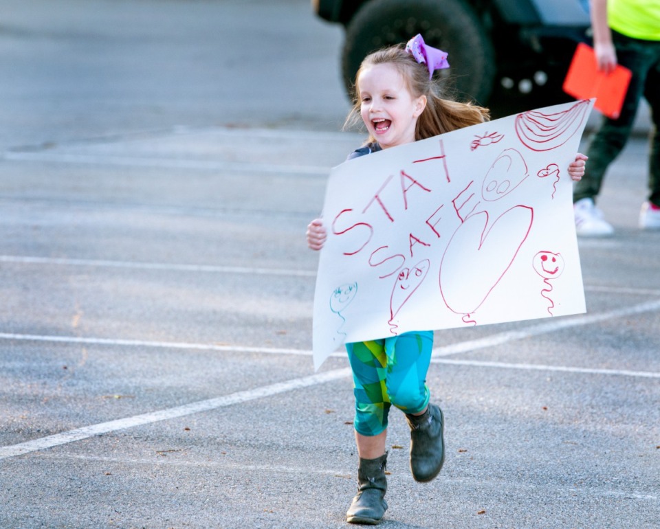 <strong>Sara Kate Netherton, 5, runs with excitement after seeing nurses coming out of Baptist Memorial Hospital- Collierville during shift change Sunday night, March 29, 2020. Netherton and about two dozen showed up to show their support to the health care workers.</strong> (Greg Campbell/Special to The Daily Memphian)