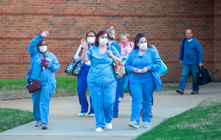 <strong>Nurses and staff exit Baptist Memorial Hospital-Collierville after their shift Sunday night, March 29, 2020. A group showed up with signs of encouragement to show their appreciation for the health care workers.</strong> (Greg Campbell/Special for The Daily Memphian)