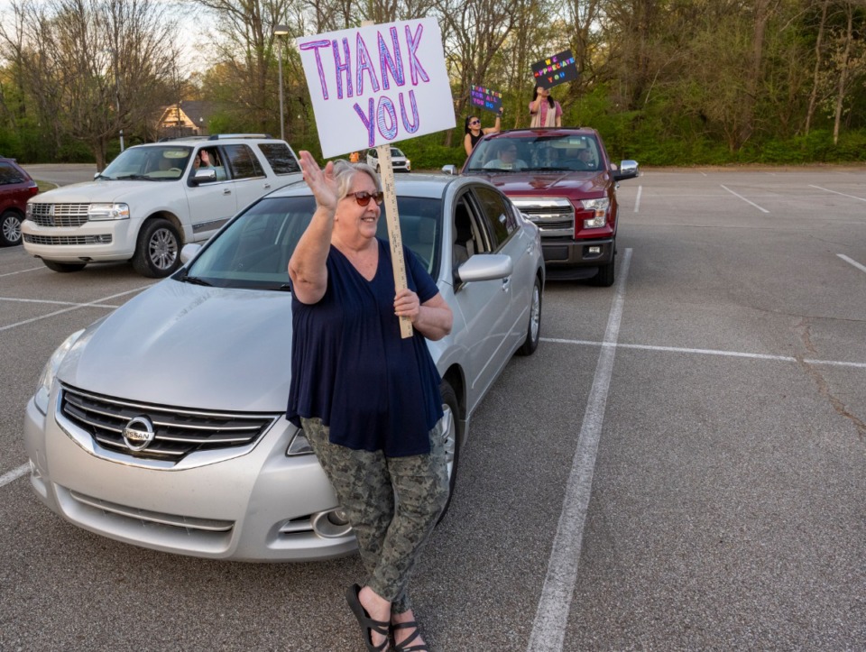 <strong>Renda Craig waves to nurses and staff leaving Baptist Memorial Hospital-Collierville to show support during the COVID-19 virus crisis. A group of Collierville citizens showed up Sunday night, March 29, 2020, during shift change to offer thanks</strong>. (Greg Campbell/Special to The Daily Memphian)