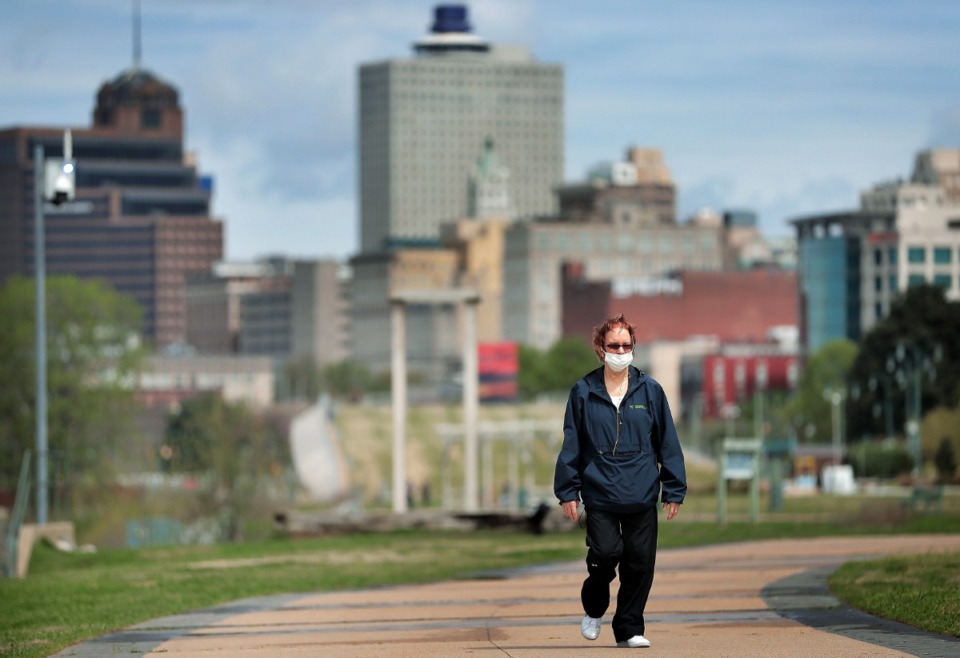 <strong>Downtown Memphis resident Lea Ohara takes a walk through a sparsely populated Tom Lee Park on March 31, 2020, after Memphis Mayor Jim Strickland announced that the city would start limiting access to city parks, including closing Riverside Drive.</strong> (Jim Weber/Daily Memphian)