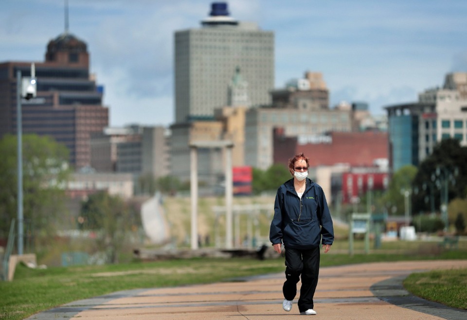<strong>Downtown Memphis resident Lea Ohara takes a walk through a sparsely populated Tom Lee Park on March, 31, 2020 after Memphis Mayor Jim Strickland announced that the city would start limiting access to city parks, including closing Riverside Drive.</strong> (Jim Weber/Daily Memphian)