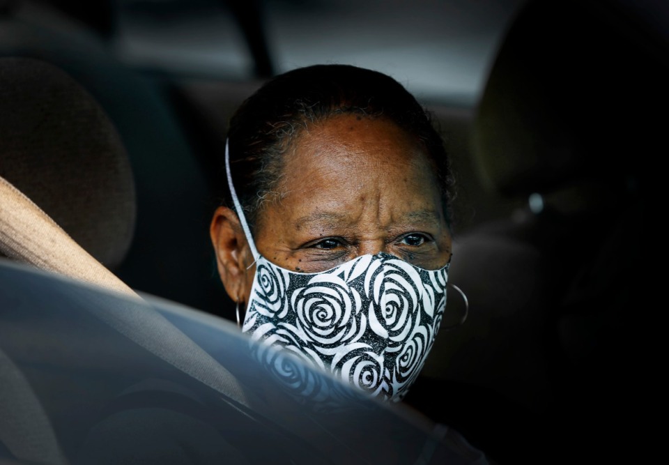 <strong>Carol Webb covers her face with a mask while attending the Mid-South Food Bank mobile pantry event Wednesday, April 1, 2020 on E. Georgia Ave.</strong> (Mark Weber/The Daily Memphian)