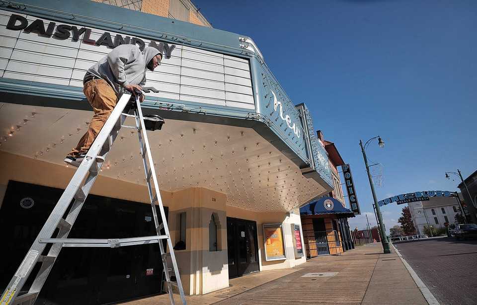 <strong>Antwan Walker letters a marquee at the New Daisy Theatre on Nov. 20, 2018, to promote a New Year's Eve EDM party. The New Daisy is near one of the new Beale Street arches that some people still feel was a missed marketing opportunity.</strong> (Jim Weber/Daily Memphian)