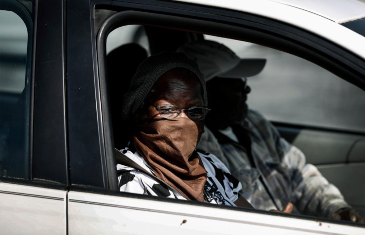 <strong>A women covers her face with a scarf while attending the Mid-South Food Bank mobile pantry event Wednesday, April 1, 2020 on E. Georgia Ave.</strong> (Mark Weber/ The Daily Memphian)