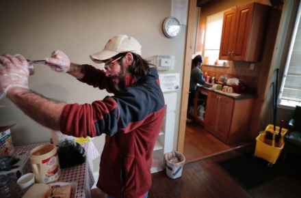 <strong>Constance Abbey community member Michael Smith tries to get the last bit of jam out of the jar while making PB&amp;J sandwiches for hungry homeless Memphians at the Downtown charity on April2, 2020.&nbsp;</strong>(Jim Weber/Daily Memphian)
