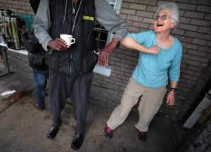 <strong>Constance Abbey co-founder Margery Wolcott greets one of her "neighbors" in as safe a fashion as possible since the onset of COVID-19 social distancing on April, 2, 2020. Constance Abbey is seeing an uptick in traffic as many churches close their doors for social distancing and other homeless facilities cut back to minimize spreading the virus.</strong> (Jim Weber/Daily Memphian)