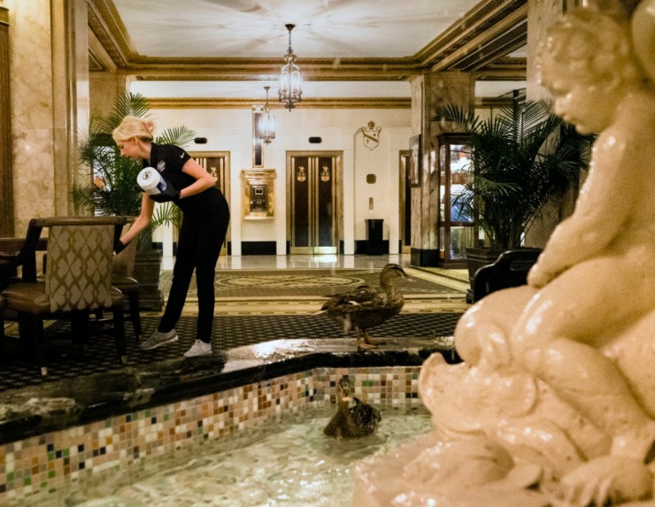 <strong>Peabody Hotel Spa Manager Katie Williams performs double duty as she sanitizes the common areas inside Peabody Hotel in Downtown Memphis on April 3, 2020.&nbsp;</strong>(Ziggy Tucker/Special to the Daily Memphian)