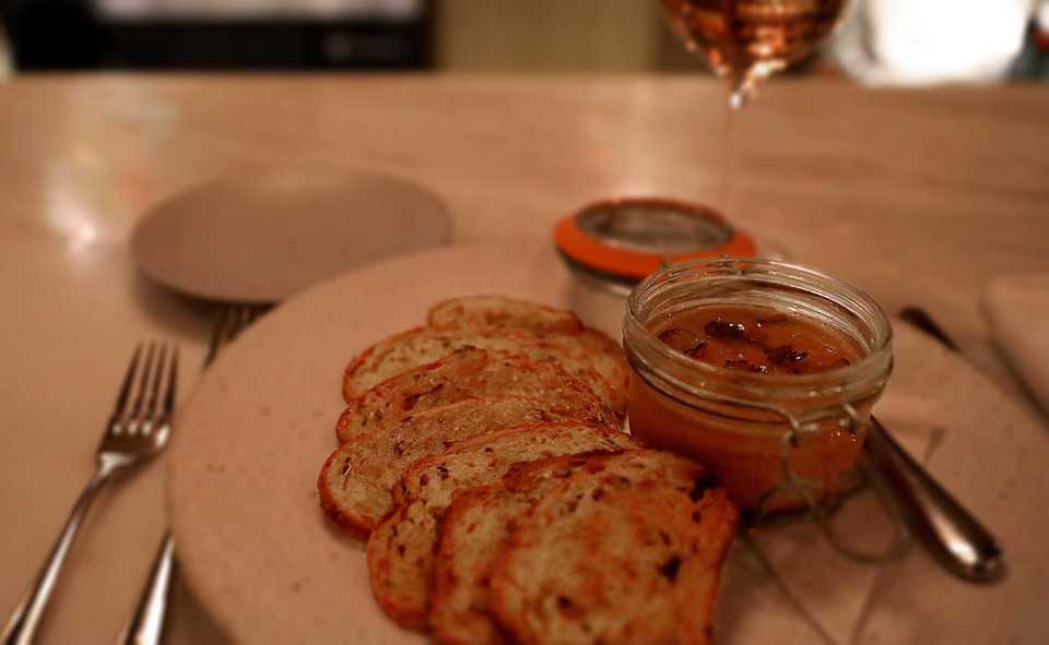 <strong>Acre's chicken liver pate, topped with a layer of truffle apple jelly and served with a fanned row of thin toasts, is a decadent delight.</strong> (Patrick Lantrip/Daily Memphian)