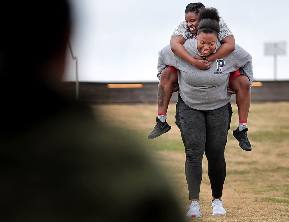 <strong>Bianca Stitts runs down the hill at Beale Street Landing carting her sister Jameka Barr during a workout&nbsp;on April 4, 2020 as Memphians practice social distancing while in public.</strong> (Jim Weber/Daily Memphian)