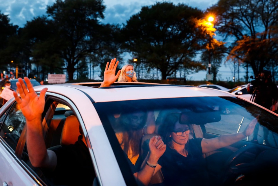 <strong>Nancy Dawson (right) and family members attend a prayer vigil for patients and staff in the St. Francis Hosptial-Memphis parking lot on Monday, April 6, 2020.</strong> (Mark Weber/Daily Memphian)