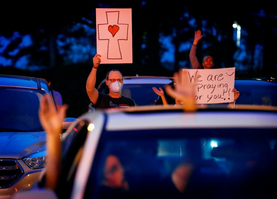 <strong>Kelley Brown (top) attends a prayer vigil for patients and staff in the St. Francis Hospital-Memphis parking lot on Monday, April 6, 2020.</strong> (Mark Weber/Daily Memphian)