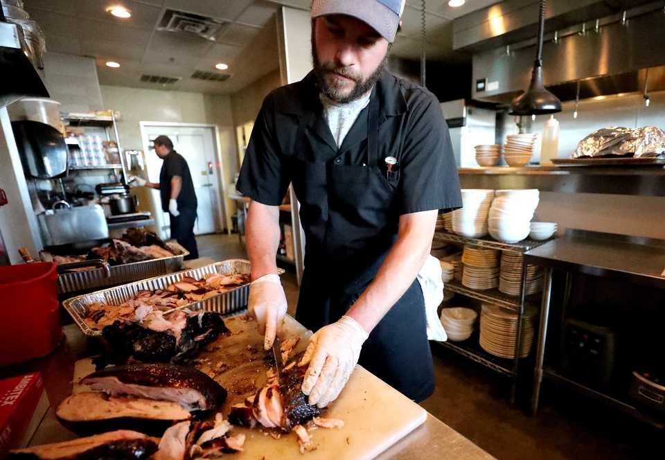<strong>Russell Casey, chef at Bounty on Broad, slices turkey in the restaurant's kitchen in preparation for serving a free Thanksgiving meal to children and families affiliated with the Family Safety Center. This year is the first time the restaurant has served the Family Safety Center, a non-profit that provides assistance to victims of domestic violence.&nbsp;</strong>(Houston Cofield/Daily Memphian)