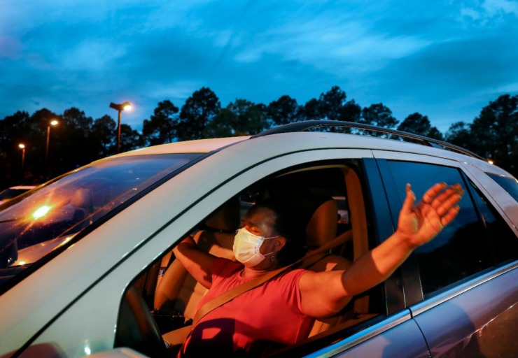 <strong>Inez Todd waves her hands in praise</strong>&nbsp;<strong>while attending a prayer vigil in the hospital parking lot for patients and staff on Monday, April 6, 2020.</strong> (Mark Weber/Daily Memphian)