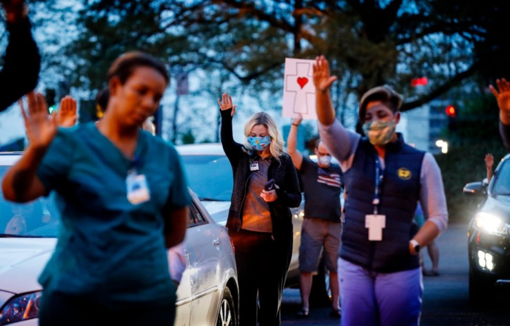<strong>St. Francis Hospital-Memphis nurses and staff attend a prayer vigil in the parking lot for patients on Monday, April 6, 2020.</strong> (Mark Weber/Daily Memphian)
