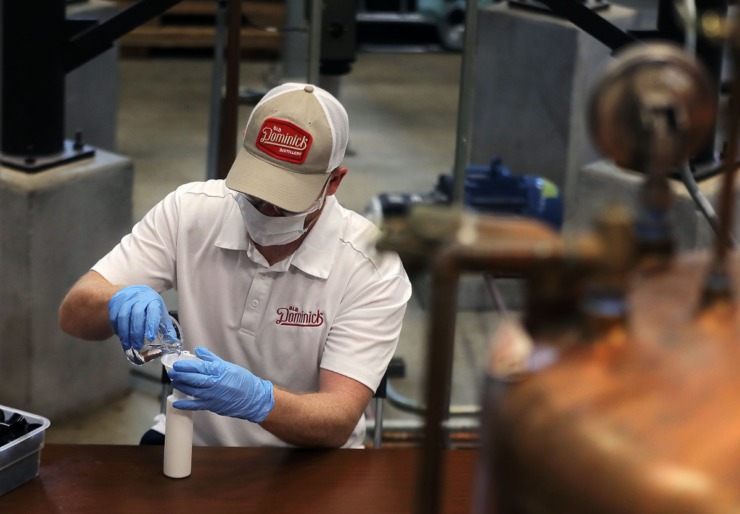 <strong>An Old Dominick Distillery employee pours a fresh batch of hand sanitizer into 6-ounce bottles on April 7, 2020. The sanitizer is being produced at the Downtown distillery thanks to an emergency resolution from the Shelby County Commission.</strong> (Patrick Lantrip/Daily Memphian)