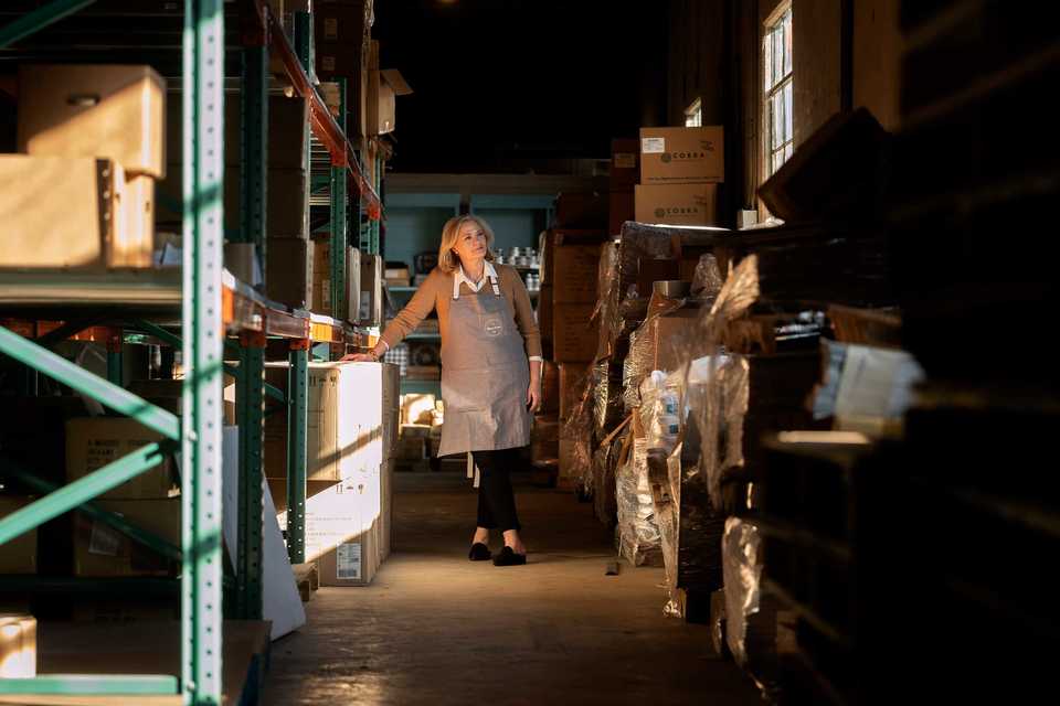 <strong>Amy Howard, owner of A Makers' Studio, stands inside the company's inventory room. Howard recently launched the business where she provides "make-and-take" workshops, as well as artisan candles made by human-trafficking survivors.</strong> (Houston Cofield/Daily Memphian)