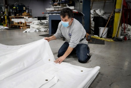 <strong>Mahaffey employee Ruben Soto folds a vinyl tent piece on Wednesday, April 8, 2020.</strong> (Mark Weber/Daily Memphian)