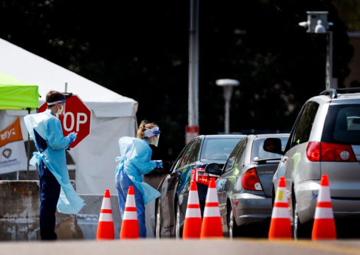 <strong>Staff and students from the University of Tennessee Health Science Center work with the Shelby County Health Department on Wednesday, April 1, 2020, to continue drive-thru testing for COVID-19 at the Memphis Fairgrounds.</strong> (Mark Weber/ The Daily Memphian)