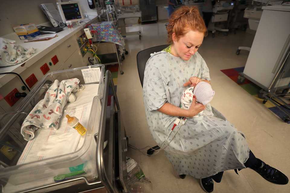 <strong>Nurse Nikki Hannegan spends a quiet moment with one of her tiny patients in October at Regional One Health's neonatal intensive care unit (NICU).&nbsp;</strong>(Jim Weber/Daily Memphian)