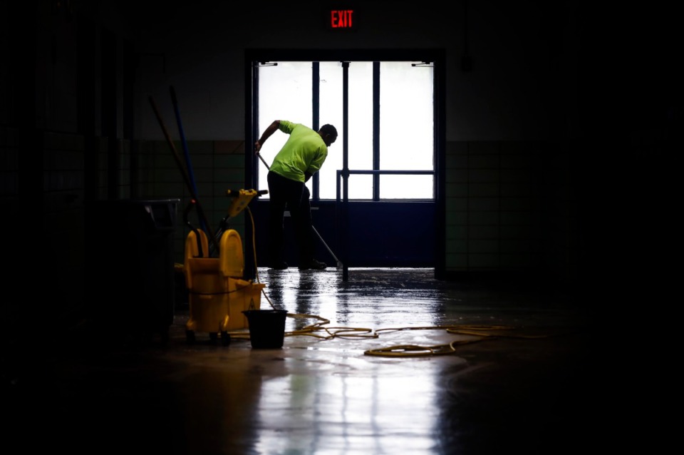 <strong>KIPP Memphis Collegiate High maintenance man Antoine Shotwell cleans floors at the school on April 3, 2020. In anticipation of students returning, cleaning crews worked to disinfect the school while it was closed due to the COVID-19 pandemic; emergency rules were approved Thursday, April 9, to guide Tennessee schools during the coronavirus crisis to &ldquo;cover the possibility that schools will not resume.&rdquo;</strong> (Mark Weber/Daily Memphian)