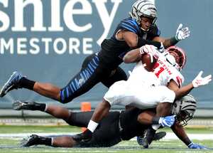 <strong>Houston Cougars running back Patrick Carr (21) is brought down by two Memphis Tigers defensive backs&nbsp;</strong><span class="s1"><strong>during the matchup Friday, Nov. 23, at Liberty Bowl Memorial Stadium. </strong>(Houston Cofield/Daily Memphian)</span>