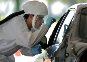 <strong>A UTHSC doctor swabs a patient during a drive-thru COVID-19 test at Tiger Lane April 10, 2020.</strong> (Patrick Lantrip/Daily Memphian)