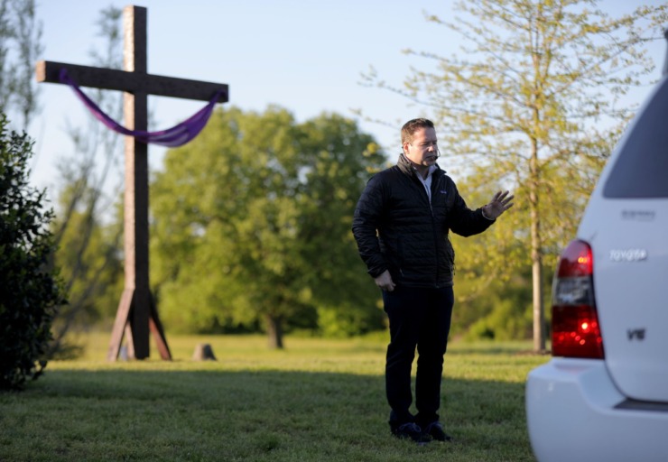<strong>Chris Foster, lead pastor of the Cathedral of Praise church, blesses a parishoners car during his church's Good Friday Drive-Thru Communion service April 10, 2020.</strong> (Patrick Lantrip/Daily Memphian)