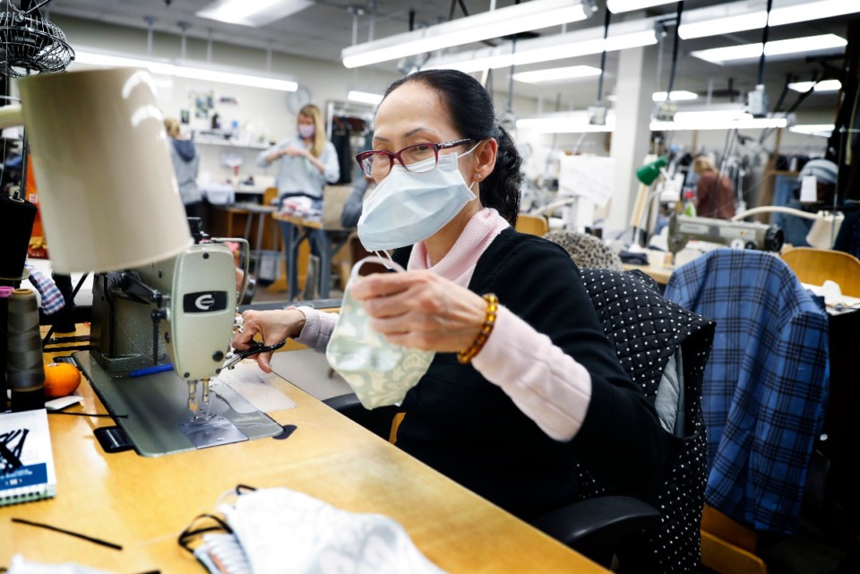 <strong>Oak Hall seamstress Susan Nguyen stitches a face mask from new shirts and donated materials on Monday, April 13, 2020. Oak Hall sold 1,200 masks in the first 12 hours of the sale, and for every mask they sell they are donating one to Church Health.</strong> (Mark Weber/Daily Memphian)
