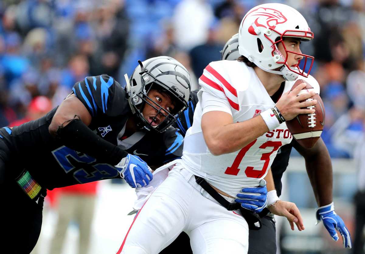 <strong>Houston quarterback Clayton Tune (13) is sacked by University of Memphis linebacker JJ Russell (23)&nbsp;<span class="s1">during the matchup Friday, Nov. 23, at Liberty Bowl Memorial Stadium.&nbsp;</span></strong>(Houston Cofield/Daily Memphian)