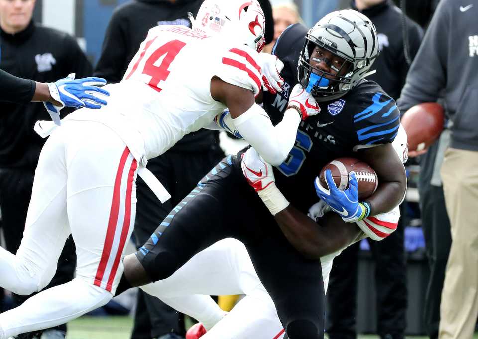<strong>University of Memphis running back Patrick Taylor Jr. (6) is tackled by Houston corner back Isaiah Johnson after a big running gain by the Tigers against the Cougars&nbsp;<span class="s1">during the matchup Friday, Nov. 23, at Liberty Bowl Memorial Stadium.</span>&nbsp;</strong>(Houston Cofield/Daily Memphian)