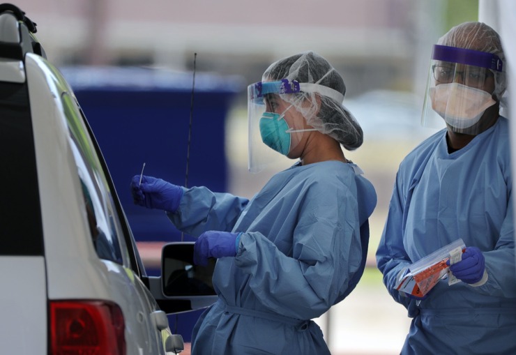 <strong>A doctor prepares to swab a patient at Christ Community Health's drive-thru COVID-19 testing site in Whitehaven on April 13, 2020.</strong> (Patrick Lantrip/Daily Memphian)