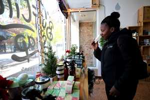 <strong>Kimbra McBride, a regular shopper at Buff City Soap, browses the store's soap selection to restock her bathroom. Buff City Soap is among the Memphis businesses participating in Small Business Saturday to promote an alternative to big-box stores.</strong> (Houston Cofield/Daily Memphian)